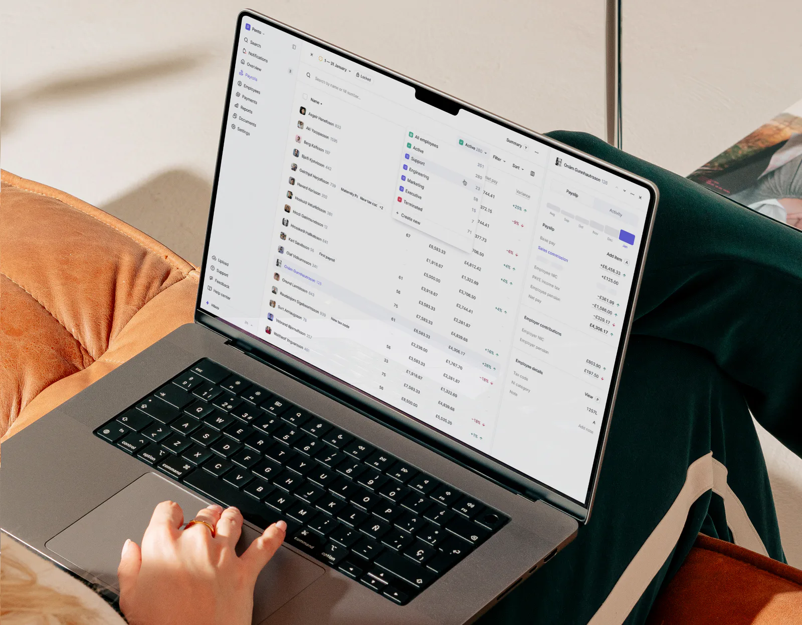 Pento's payroll table on a laptop, with an employee's payslip open beside it